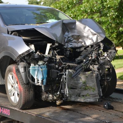 crashed car on tow truck Damaged car on a tow truck after a crash