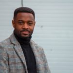 African American Headshot with a grey suit coat