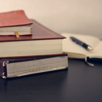 mikhail-pavstyuk-EKy2OTRPXdw-unsplash Law books and a pen on a desk