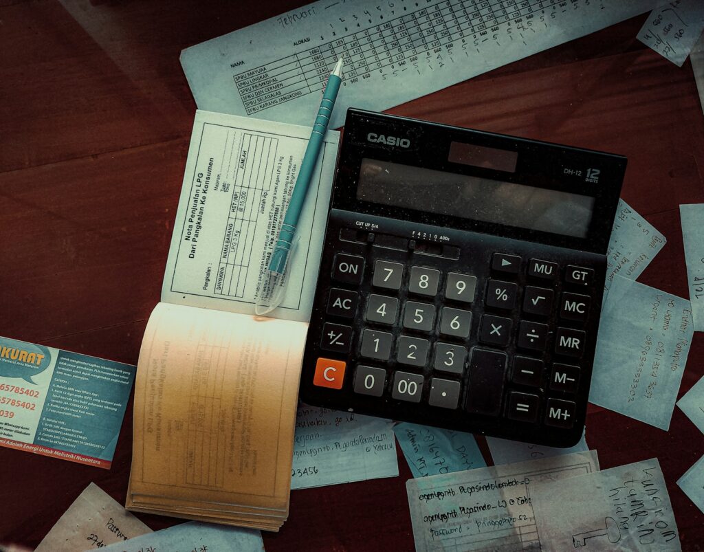 Calculator and pay records used to check a final paycheck