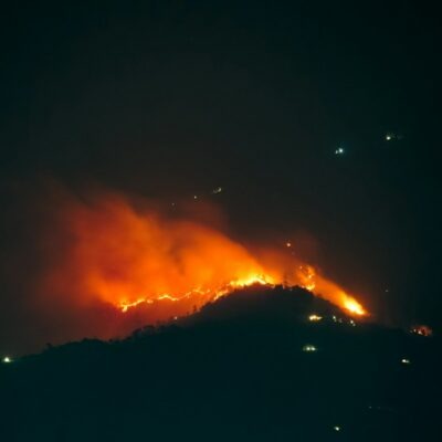Wildfire burning at night - California utility wildfire damage claims