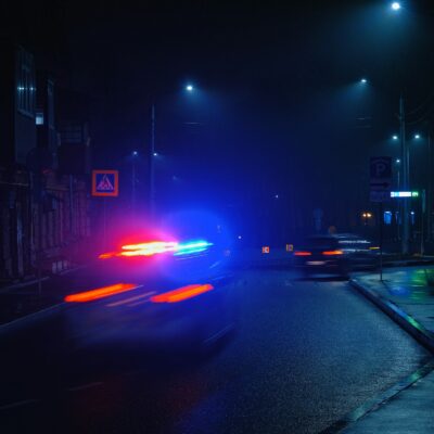 City street at night with passing traffic City street at night with passing traffic