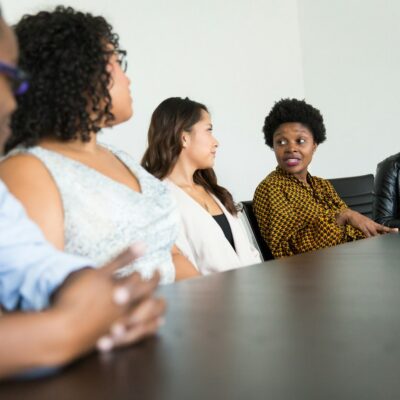 Diverse coworkers talking around a table Diverse coworkers talking around a table