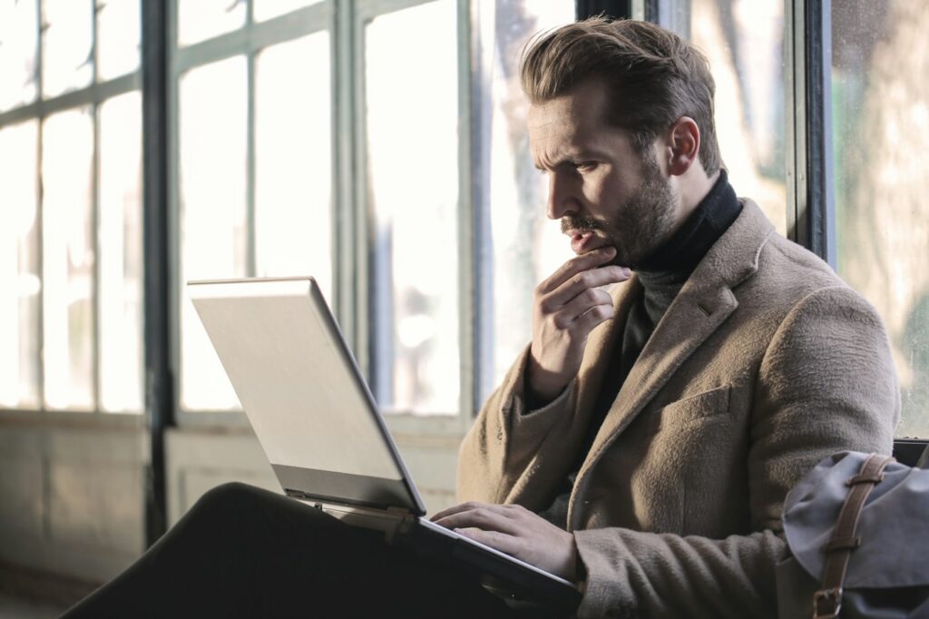 Employee thinking about reporting fraud at work