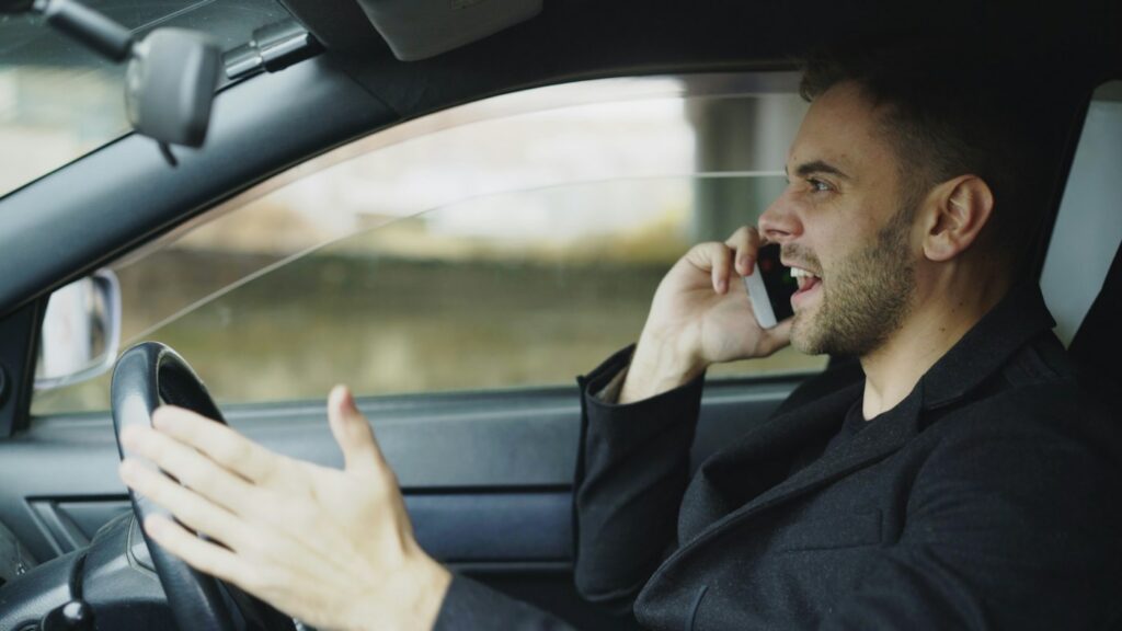 Employee driving a personal car and using a phone for work
