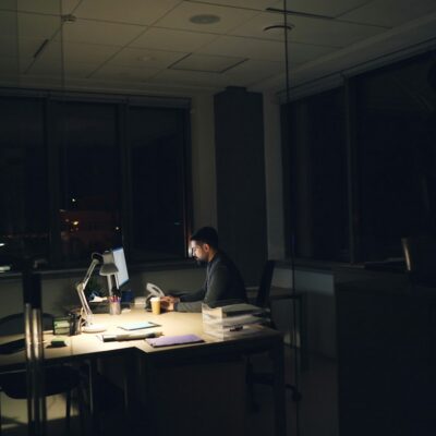 Employee working late at an office desk Employee working late at an office desk