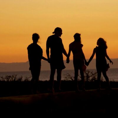 Family holding hands at sunset Family holding hands at sunset