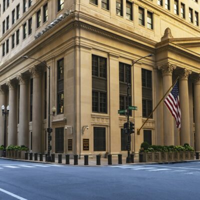 Federal building with columns and an American flag Federal building with columns and an American flag