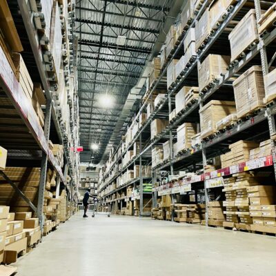 Warehouse aisle with stacked inventory Warehouse aisle with stacked inventory
