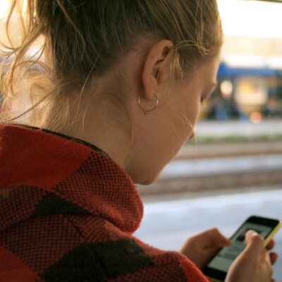 Young person holding a phone - claims for children harmed online