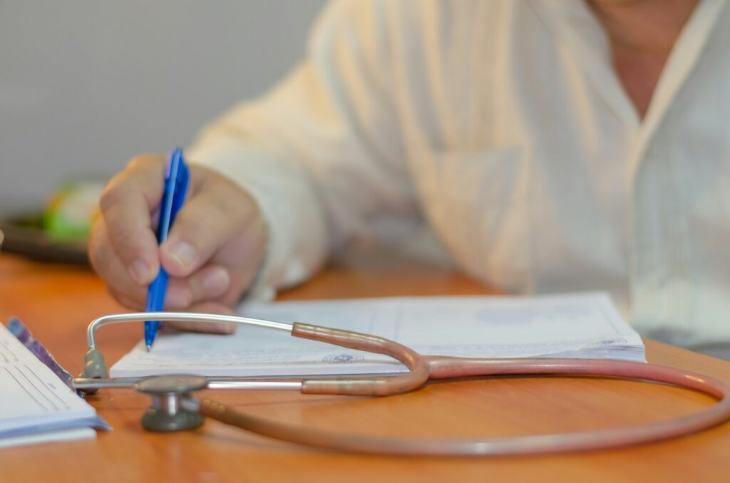 Doctor completing medical leave certification paperwork