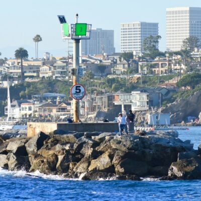 Newport Harbor jetty and Newport Beach skyline - employee rights attorney Newport Harbor jetty and Newport Beach skyline - employee rights attorney