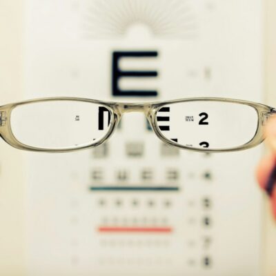 ozempic-vision-loss-naion-lawsuit-photo Person holding a pair of eyeglasses