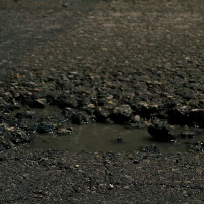 Pothole in a damaged road surface