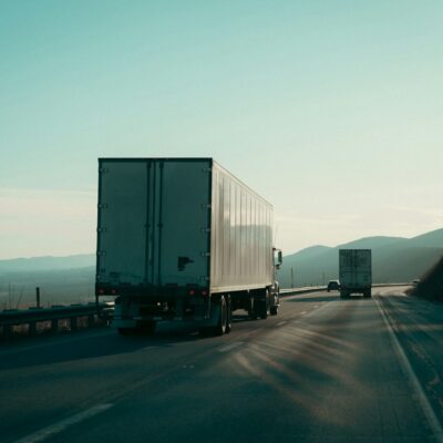 Two semi-trucks on a highway Two semi-trucks on a highway