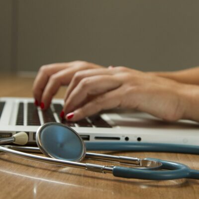 Stethoscope beside a laptop