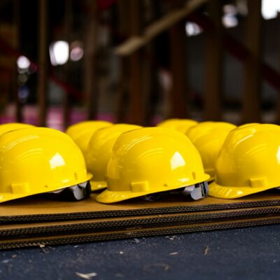 Row of yellow hard hats - California workers' compensation fraud Row of yellow hard hats - California workers' compensation fraud